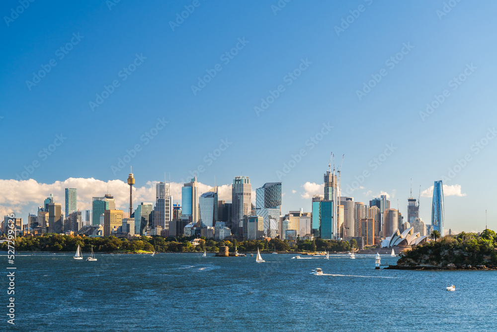 Naklejka premium Beautiful panorama of Sydney city skyline viewed across the harbour from the Taronga Zoo Wharf on a bright day