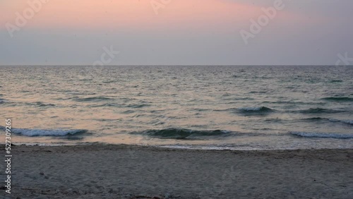 Pink sunset on ocean waves