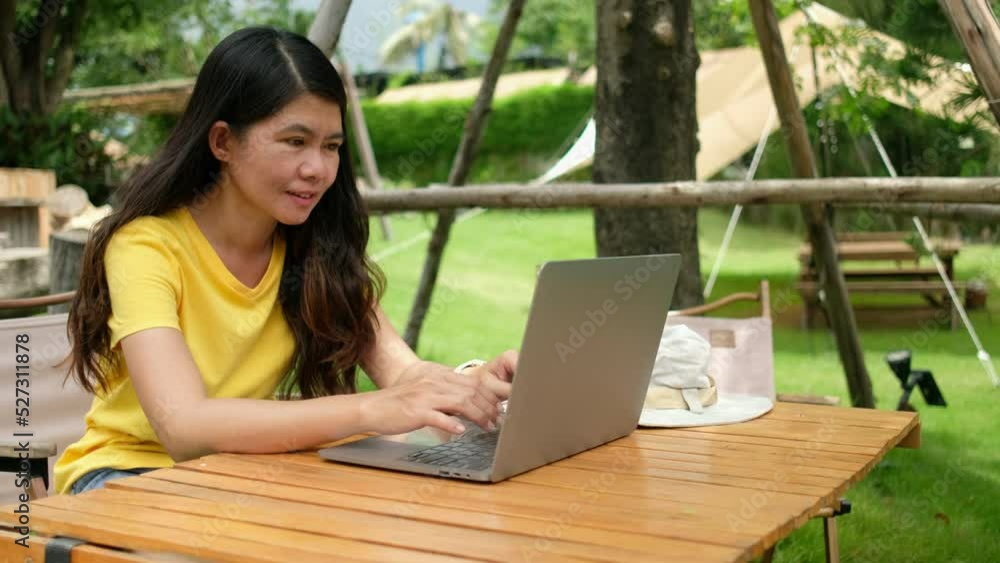 Asian woman using labtop to work in the garden at home. businesswoman communication online. Asian woman using labtop to work in the garden at home. businesswoman communication online.