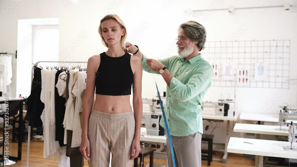 Team of fashion designers at work in a clothing design studio Team of fashion designers at work in a clothing design studio