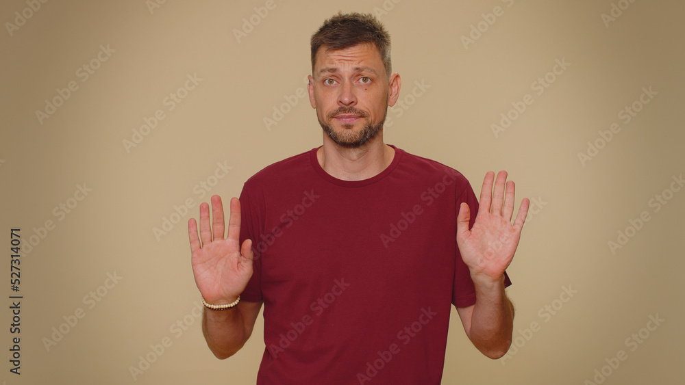 I am not guilty. Puzzled guilty young man pointing fingers hisself ask say who me no thanks i do not need it, refusal. Adult stylish male guy isolated alone on beige studio wall background indoors I am not guilty. Puzzled guilty young man pointing fingers hisself ask say who me no thanks i do not need it, refusal. Adult stylish male guy isolated alone on beige studio wall background indoors
