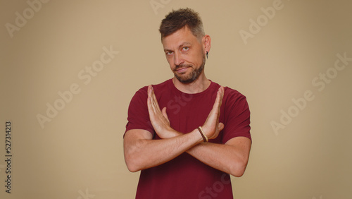 I am dont want it, not me. Confused upset young man pointing fingers hisself ask say who why me no thanks i do not need it, rejection, refusal, stop sign. Adult stylish guy on beige background