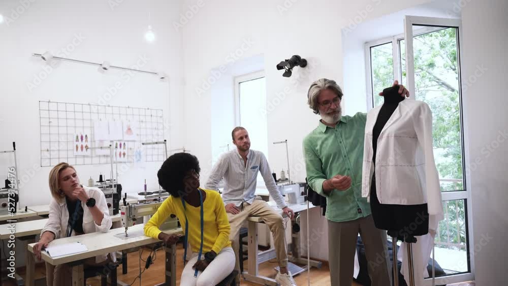 Team of fashion designers at work in a clothing design studio Team of fashion designers at work in a clothing design studio