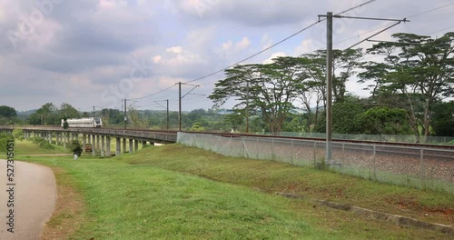 Train of the Kuala Lumpur Airport Express line or KLIA Express on the way to the city. Highspeed train connecting the airport train station with KL Central. Fast modern highspeed train on the track  photo