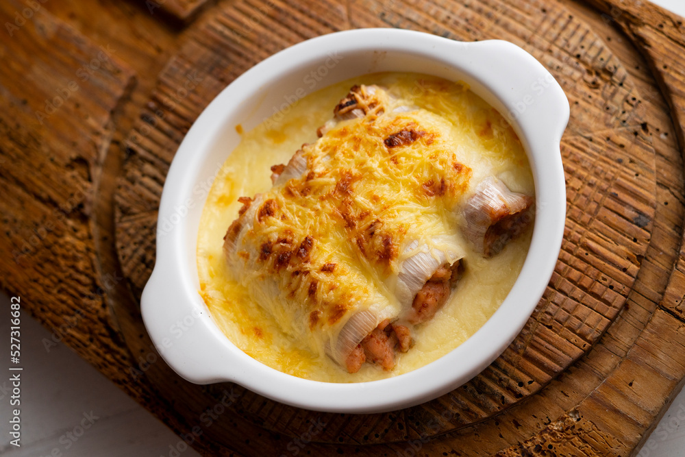 Meat cannelloni with bechamel sauce and gratin cheese. Traditional Spanish Christmas Tapa.