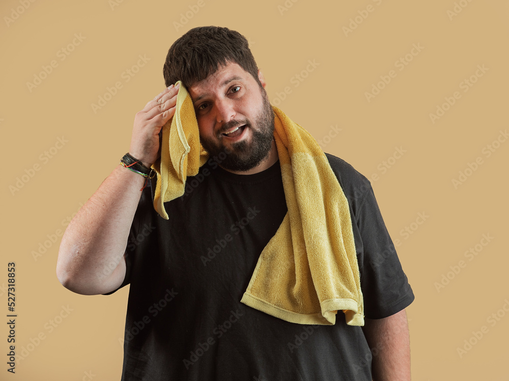 man after exercising wipes off sweat with towel man after exercising wipes off sweat with towel