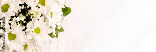 Leinwand Poster Bouquet of white chamomile chrysanthemums on white background banner with copy space