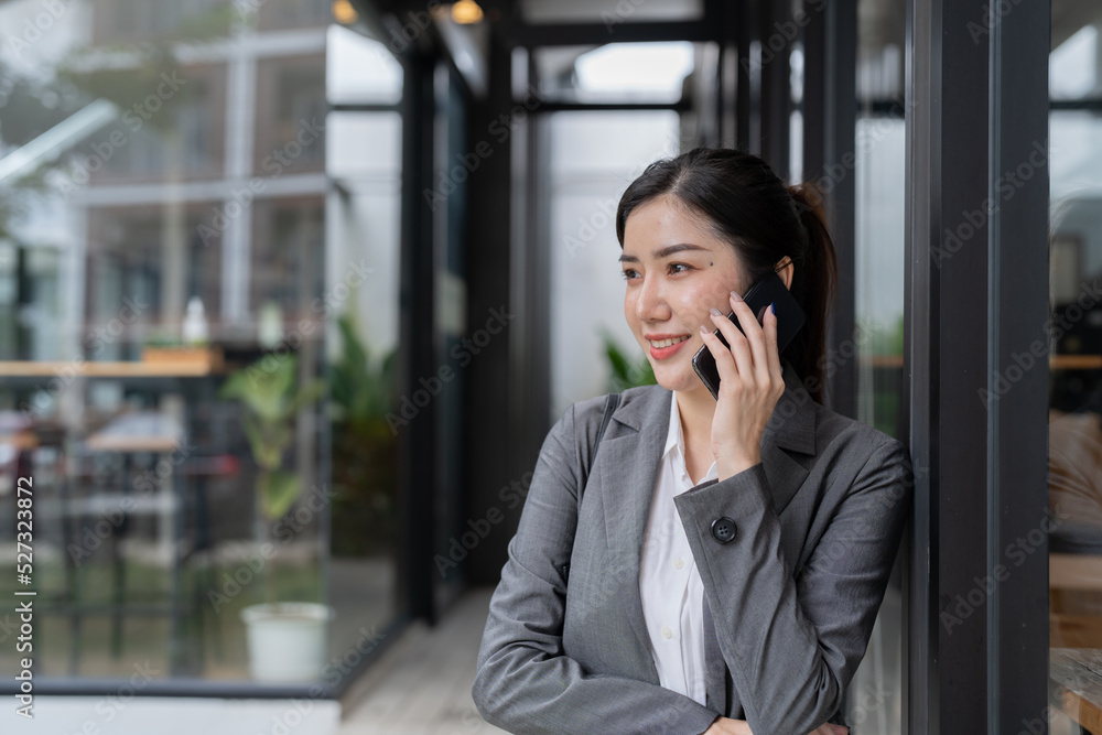 Smiling asian business woman making a phone call Smiling asian business woman making a phone call