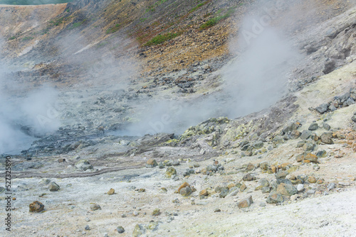 boiling and steaming hydrothermal outlet on the shore of the hot lake in the caldera of the Golovnin volcano on the island of Kunashir