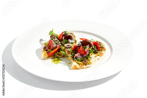 Tapas with avocado cream, anchovy, paprika and kalamata olives on focaccia. Bruschetta with guacamole and anchovy isolated on white background. Appetizer contemporary concept. Fish antipasti.