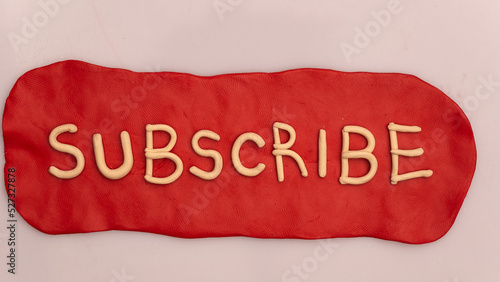 Plasticine red subscribe button on a white background.
