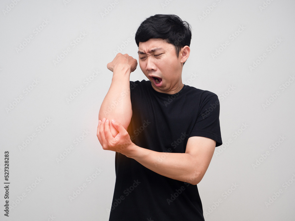Man black shirt feels pain his elbow isolated Man black shirt feels pain his elbow isolated