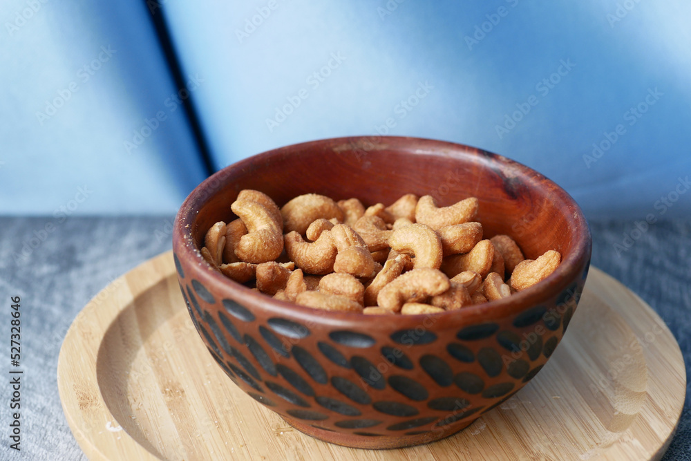 cashew nuts in a wooden bowl on table cashew nuts in a wooden bowl on table
