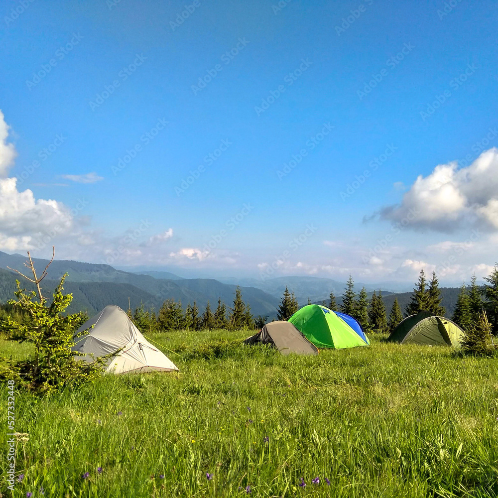 a tent on the slopes of high mountains, magical nature, endless sky