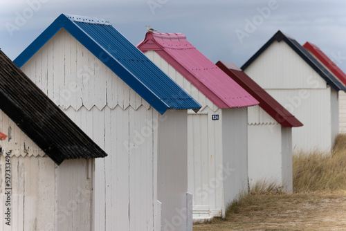 Fotografiet Beach cabins in Gouville sur Mer, Manche, Normandy, France in various lights