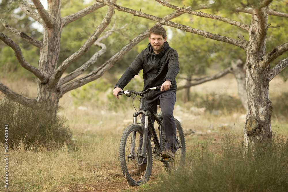 a young man rides a mountain bike in the forest a young man rides a mountain bike in the forest