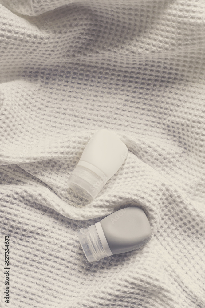 Naklejka premium lotion tube mockup isolated on white fabric background.