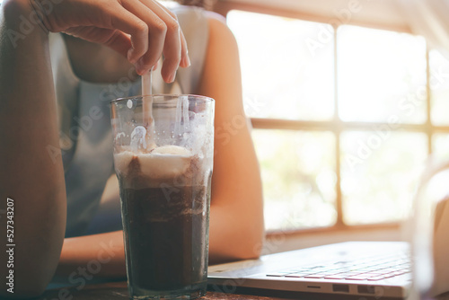 girl drinking cocoa while working,relaxing at work,indoor cafe