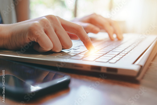 woman using laptop,working at home,hand of female with close up shot,technology concept