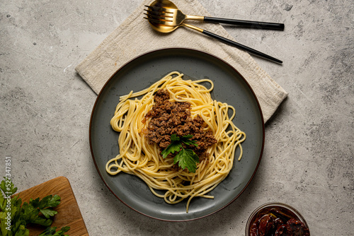 Spaghetti Bolognese in the grey plate on the grey backgroundSpaghetti Bolognese photo