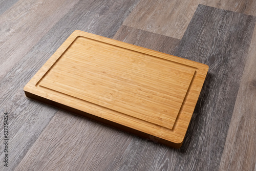 Empty cutting board on a wooden table, close-up, copy space for text.