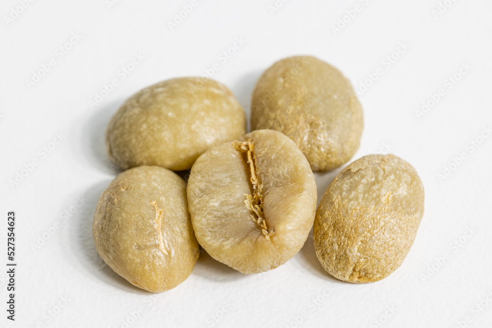 unroasted coffee beans on white background unroasted coffee beans on white background