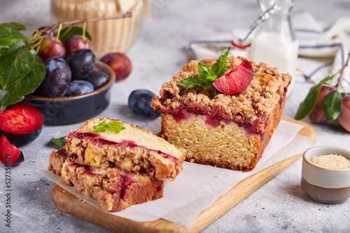 Pound cake with plums, cinnamon and streusel. Delicious autumn homemade dessert. 