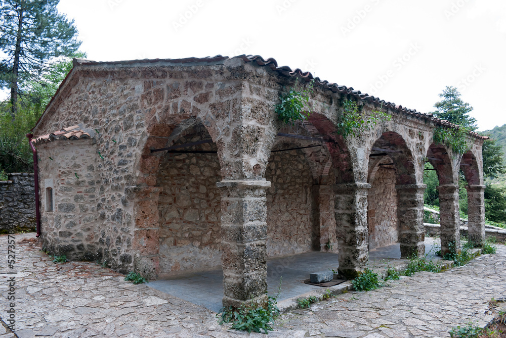 Stemnitsa, Greece / July 2022: Historic traditional village at the slopes of Mainalon mountain in the Peloponnese. Medieval church.