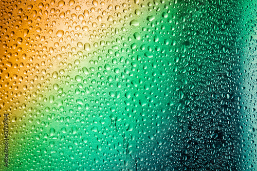 Abstract water droplets on metal surface with gradient colors.