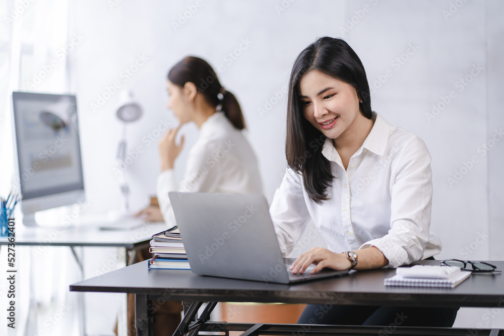 Smiling Asian businesswoman working on laptop in modern office Accountant Concept Finance Expert Analyze Business Report Graph financial chart financial chart corporate economy Banking Market Research Smiling Asian businesswoman working on laptop in modern office Accountant Concept Finance Expert Analyze Business Report Graph financial chart financial chart corporate economy Banking Market Research