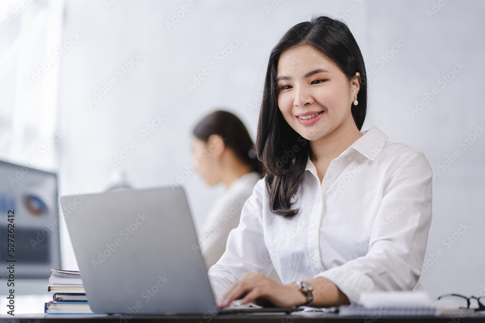 Smiling Asian businesswoman working on laptop in modern office Accountant Concept Finance Expert Analyze Business Report Graph financial chart financial chart corporate economy Banking Market Research Smiling Asian businesswoman working on laptop in modern office Accountant Concept Finance Expert Analyze Business Report Graph financial chart financial chart corporate economy Banking Market Research