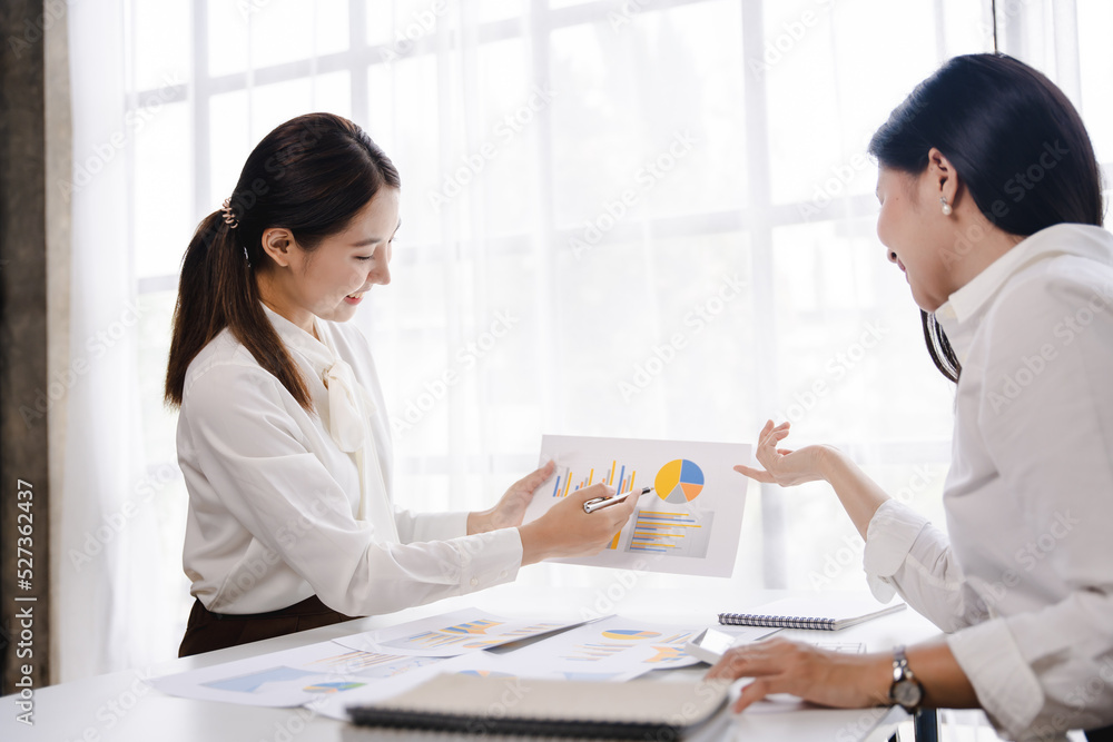 Team of Asian businessmen working in the office with documents on their desks. Planning to analyze financial reports business plan investment financial analysis concept Team of Asian businessmen working in the office with documents on their desks. Planning to analyze financial reports business plan investment financial analysis concept