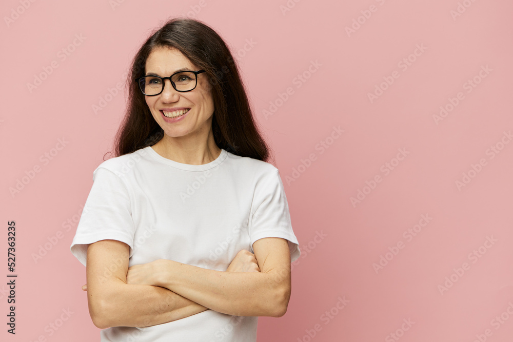 portrait of a cute, attractive brunette in a white tank top on a pink background, with a pleasant smile, standing in glasses for vision portrait of a cute, attractive brunette in a white tank top on a pink background, with a pleasant smile, standing in glasses for vision