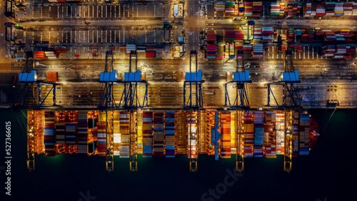 Time lapse of Container ship loading and unloading at night in port.