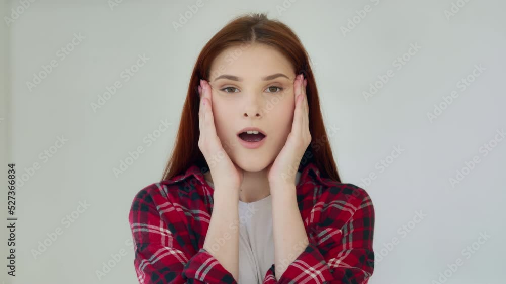 Surprised ginger girl student teenager feel good shock admiration female face excited winner says wow positive reaction holds head by hands successful result millennial young woman win lottery prize Surprised ginger girl student teenager feel good shock admiration female face excited winner says wow positive reaction holds head by hands successful result millennial young woman win lottery prize