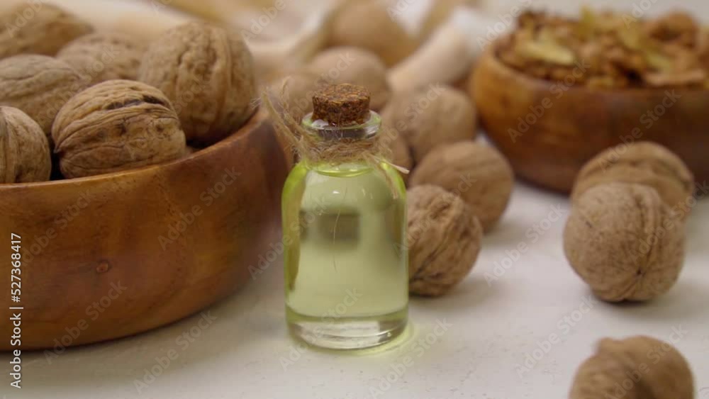 Walnut oil in glass of bottle. Healthy food for brain. Cooking and cosmetology. Slow motion Walnut oil in glass of bottle. Healthy food for brain. Cooking and cosmetology. Slow motion
