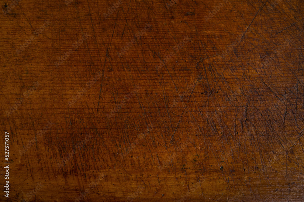 Close-up of worn antique cutting board with knife cut marks