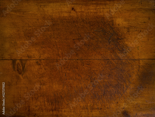 Close-up of worn antique cutting board with knife cut marks photo