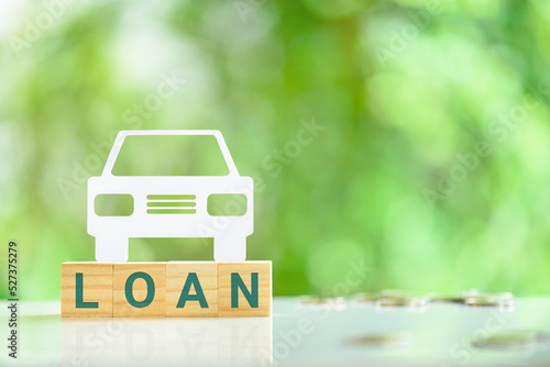 Car or auto loan, financial concept : Sedan car on wood blocks with the word LOAN. An auto loan is a secured loan, which means that the value of the vehicle serves as security for the bank or lender. photo