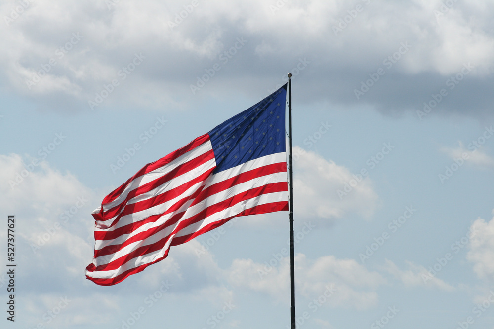 Reverse side of American Flag flying against cloudy sky Reverse side of American Flag flying against cloudy sky