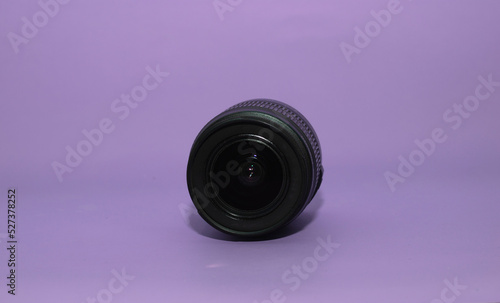 Black dslr lens on purple background