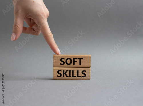 Soft skills symbol. Wooden blocks with words Soft skills. Beautiful grey background. Businessman hand. Business and Soft skills concept. Copy space.