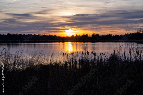 Fototapeta Naklejka Na Ścianę i Meble -  Sunset view over lakeside with beautiful colours and reflection