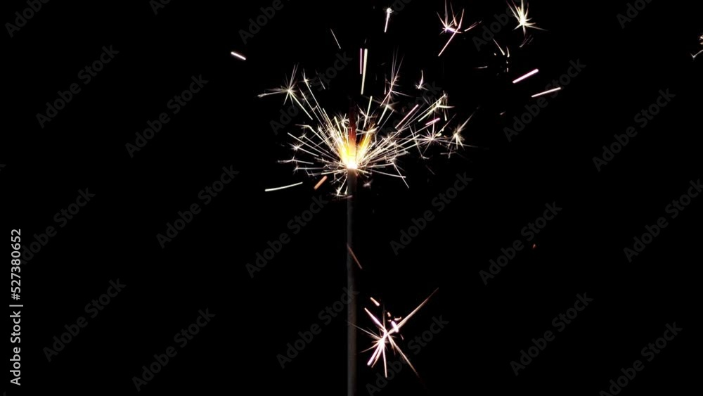 Lightening sparkler on the black background. Sparkler concept. Bengal lights are burning on a black background. Holiday party concept. Newyear party sparkler. Lightening sparkler on the black background. Sparkler concept. Bengal lights are burning on a black background. Holiday party concept. Newyear party sparkler.