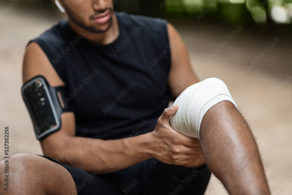 Unrecognizable black guy got trauma while jogging at park Unrecognizable black guy got trauma while jogging at park