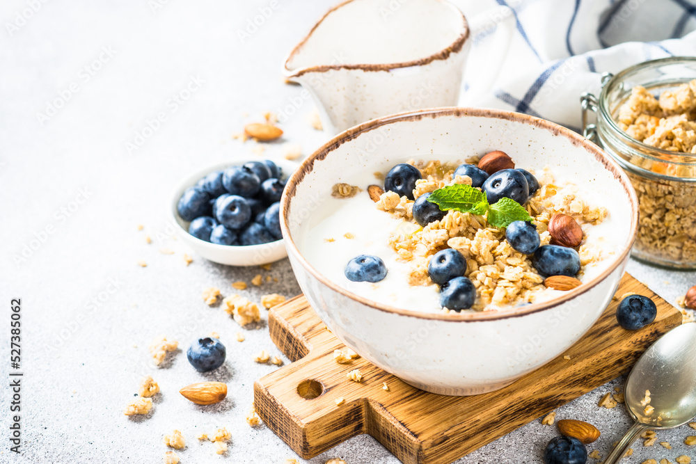 Yogurt with granola and fresh berries at stone table. Healthy food, snack or breakfast. Yogurt with granola and fresh berries at stone table. Healthy food, snack or breakfast.
