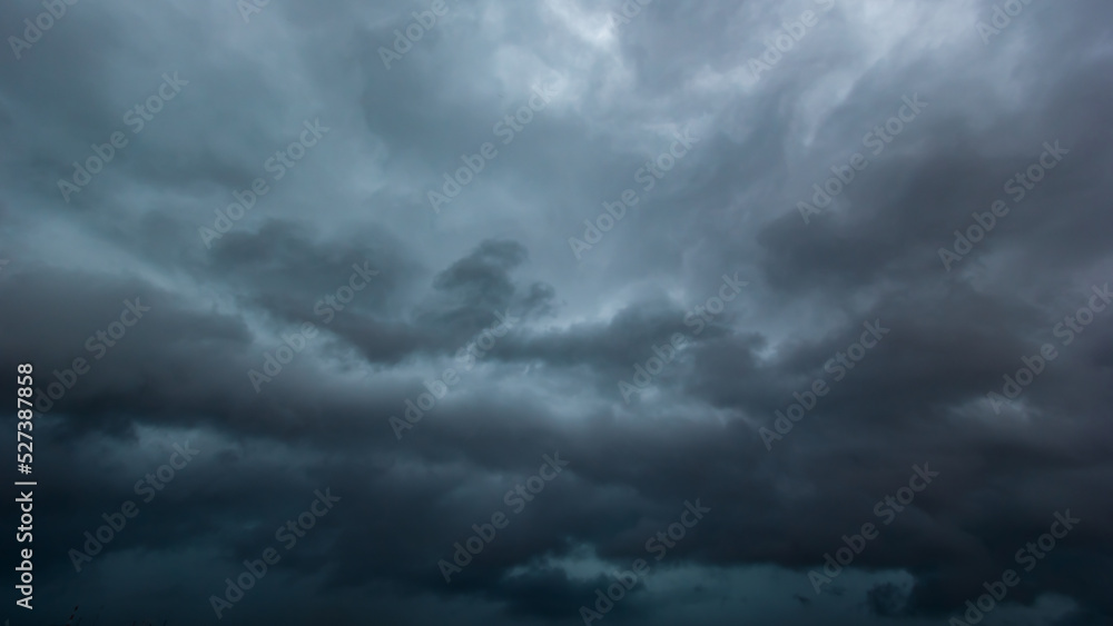 The dark sky with heavy clouds converging and a violent storm before the rain.Bad or moody weather sky and environment. carbon dioxide emissions, greenhouse effect, global warming, climate change. The dark sky with heavy clouds converging and a violent storm before the rain.Bad or moody weather sky and environment. carbon dioxide emissions, greenhouse effect, global warming, climate change.
