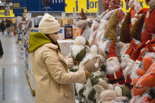 woman choosing christmas decoration toys in the store