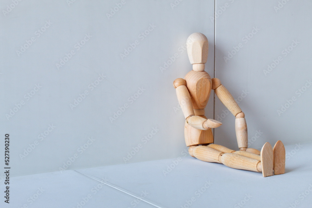 Concept of loneliness, poverty and abandonment with a wooden doll asking as a model Concept of loneliness, poverty and abandonment with a wooden doll asking as a model