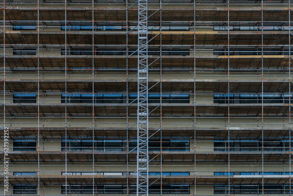 Scaffolding on the facade of the house. Restoration of the facade. Scaffolding on the facade of the house. Restoration of the facade.